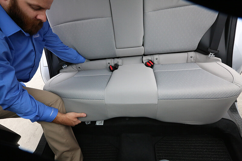 Once all fasteners, straps, and clips are separated, carefully remove the seat cover